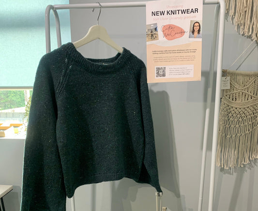 The first Bell Sweater hanging from a rail in the craft shop where it all began