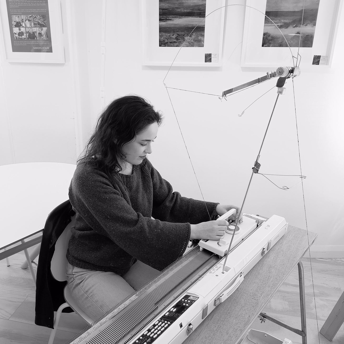 Caitlin McCracken knitting on her knitting machine