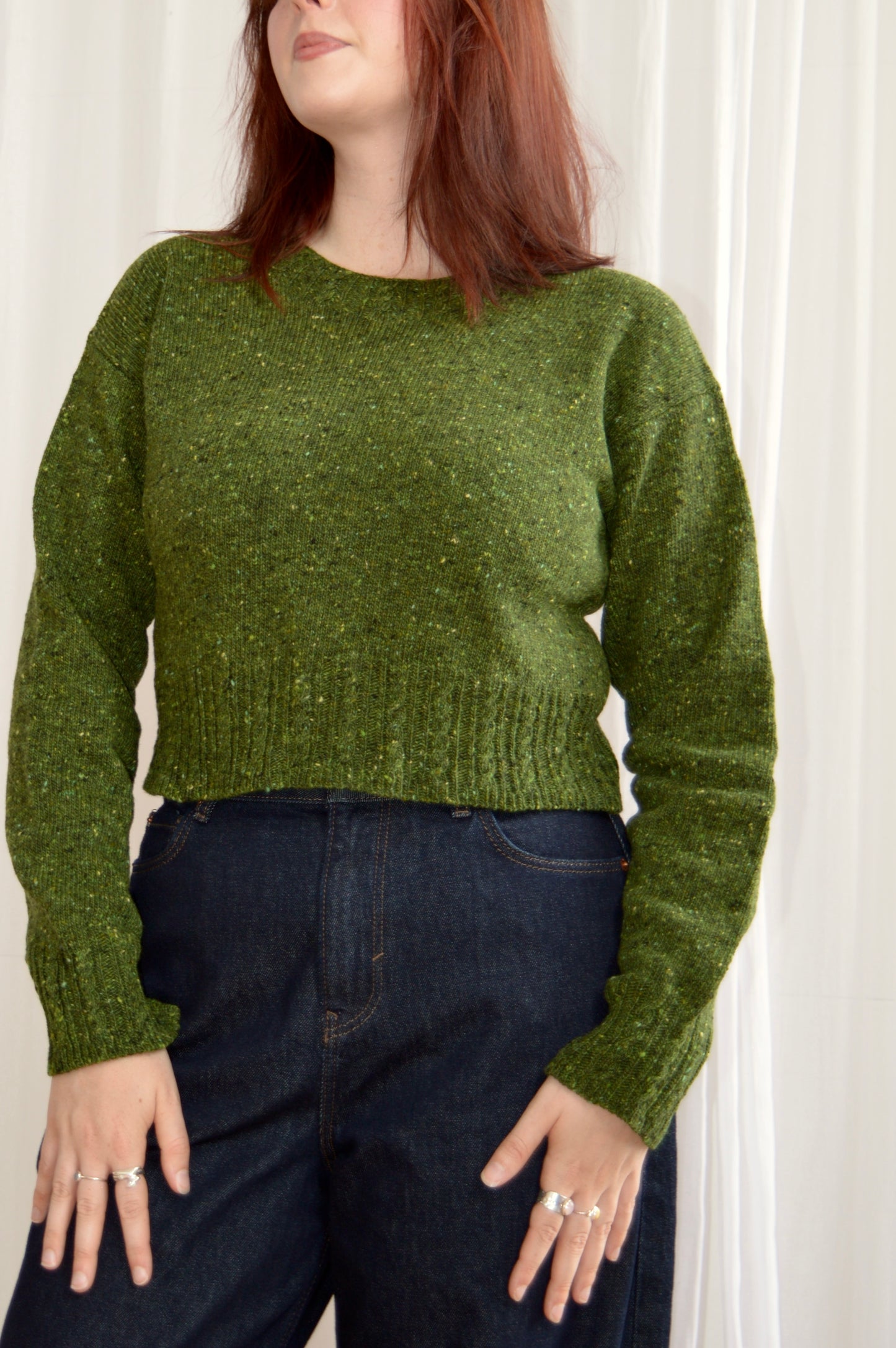 Front view of The Cable Sweater in green