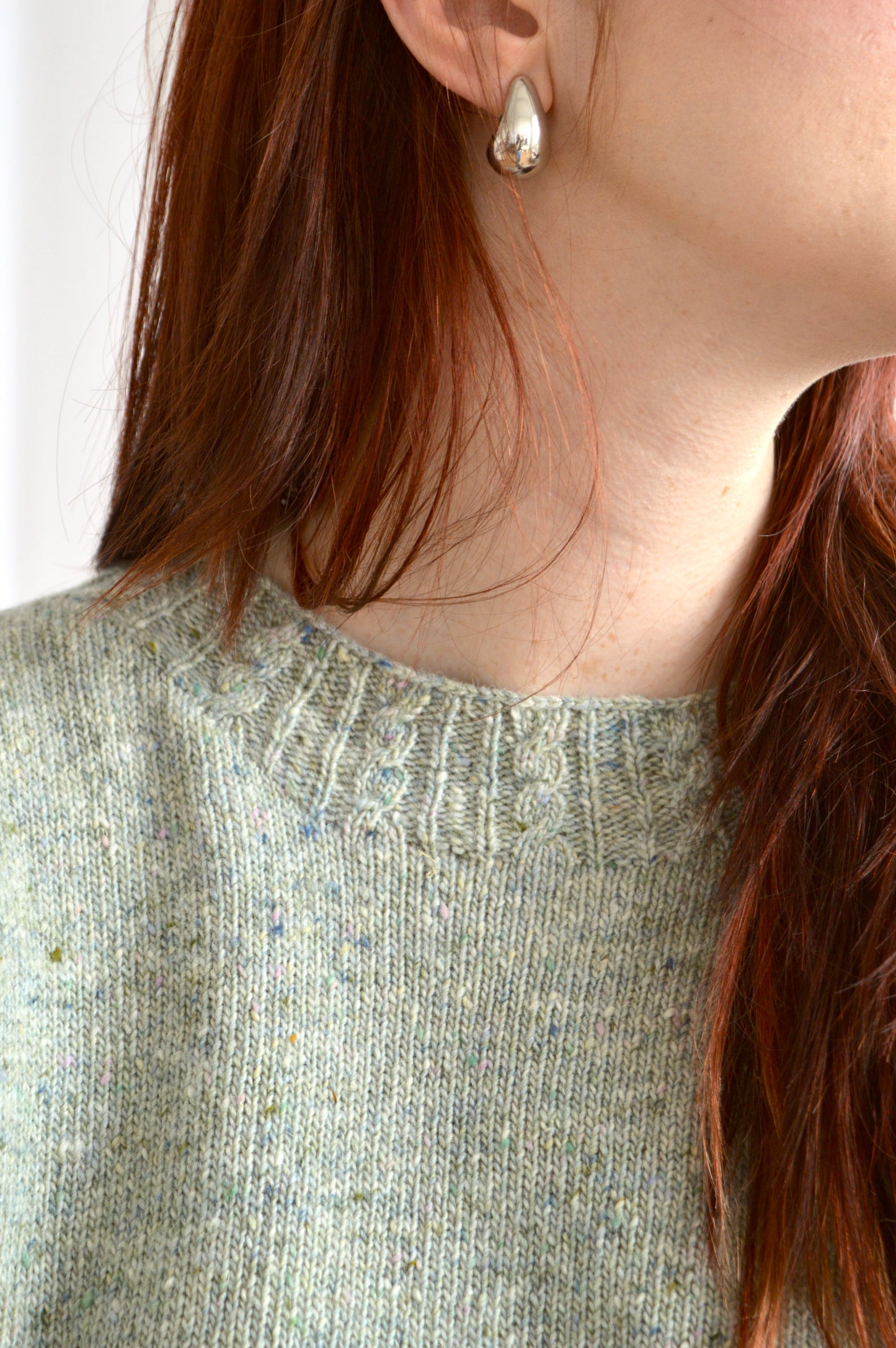 Close up neckline of The Cable Sweater in light grey