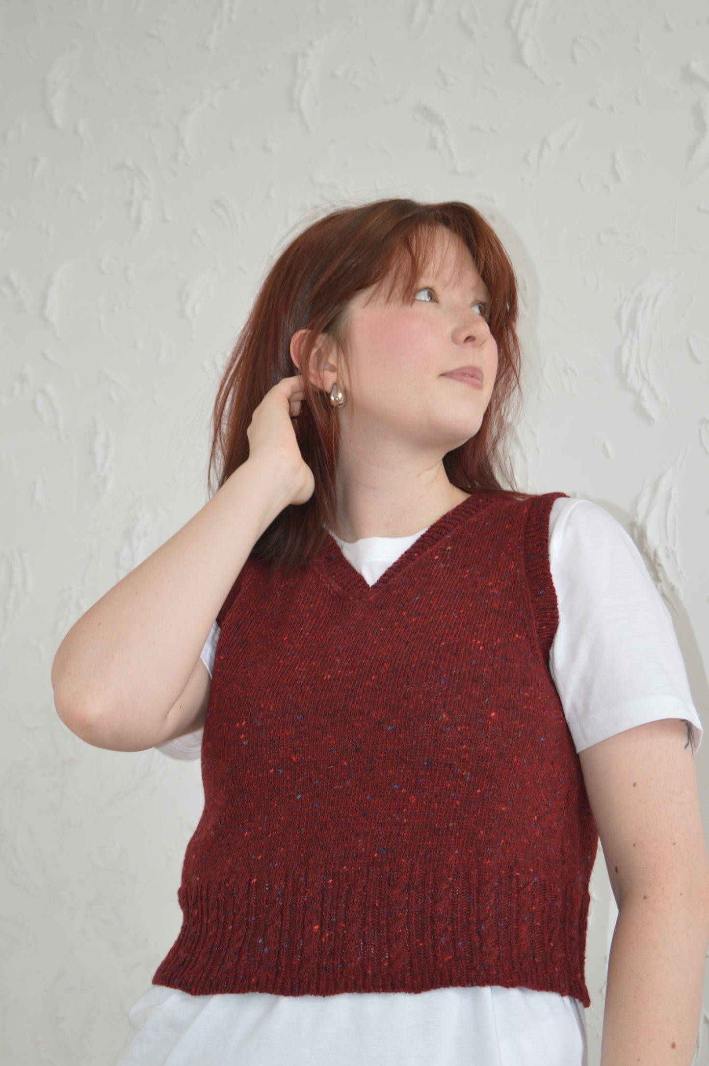 Low angle of The Cable Vest in red