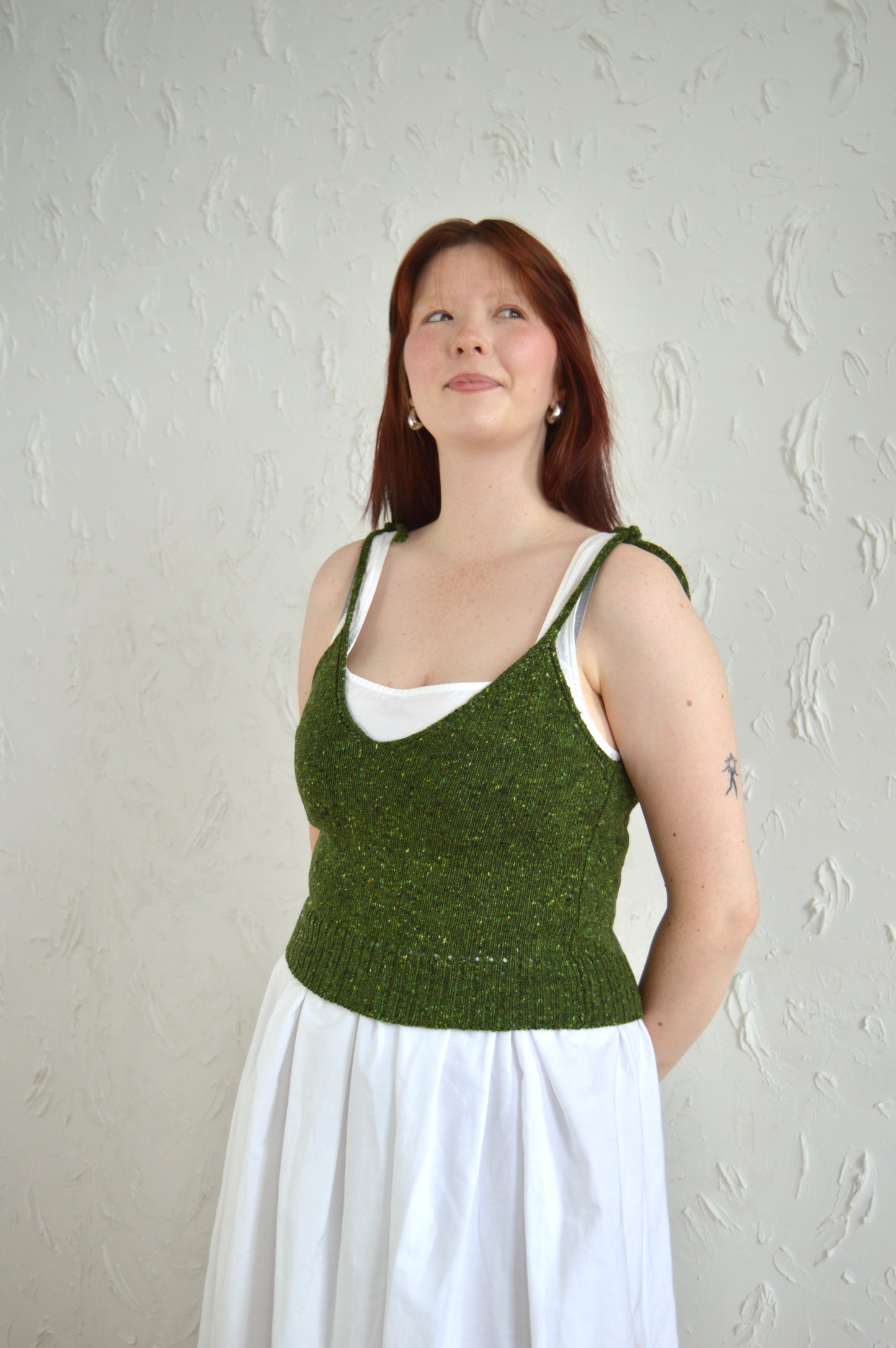 Side view of model wearing The Tie Cami in green