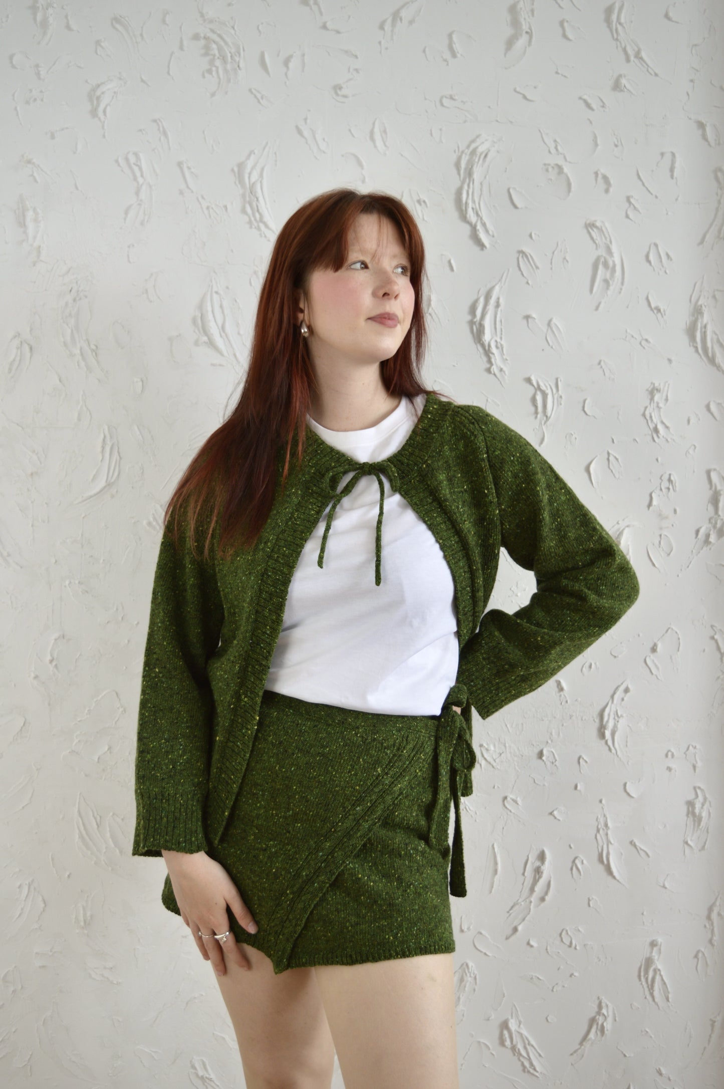 Model wearing The Wrap Skirt in green, styled with The Cosy Cardi in green
