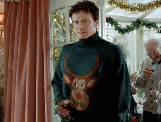 Picture of Colin Firth from Bridget Jones's Diary wearing his Christmas jumper with rudolph on the front, with an unimpressed face
