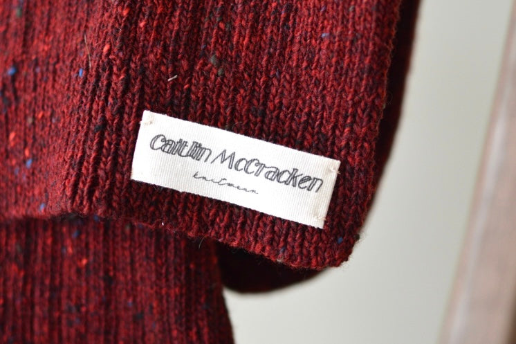 Red scarf with Caitlin McCracken Knitwear label sewn on