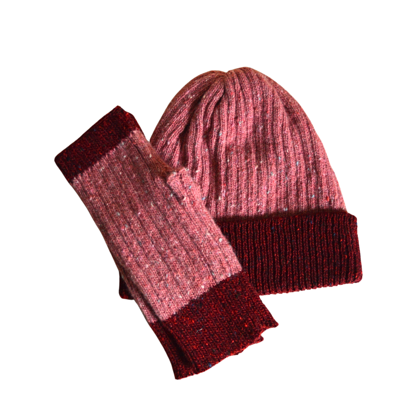 Knitted beanie and fingerless gloves set with pink and red pattern on a white background
