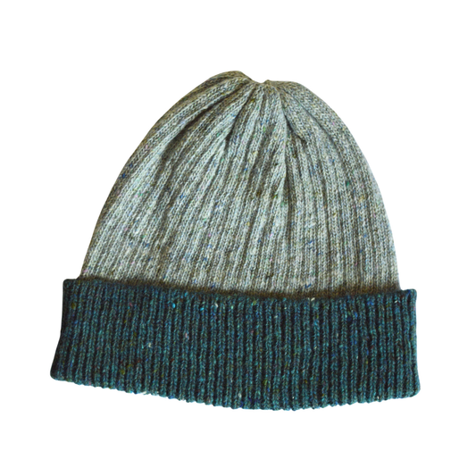 Knitted beanie with a light grey and teal pattern on a white background
