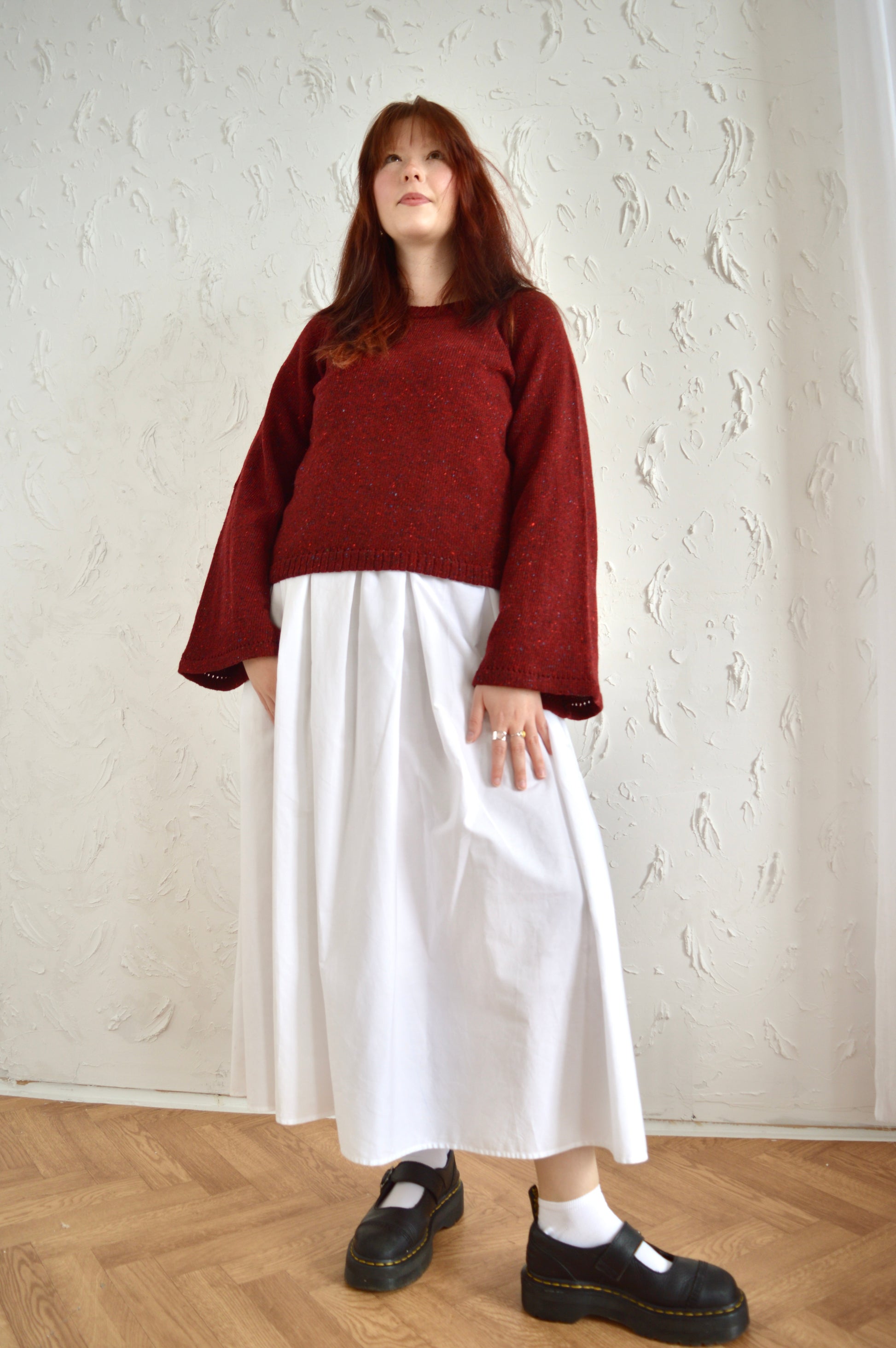 Full length view of The Bell Sweater in red