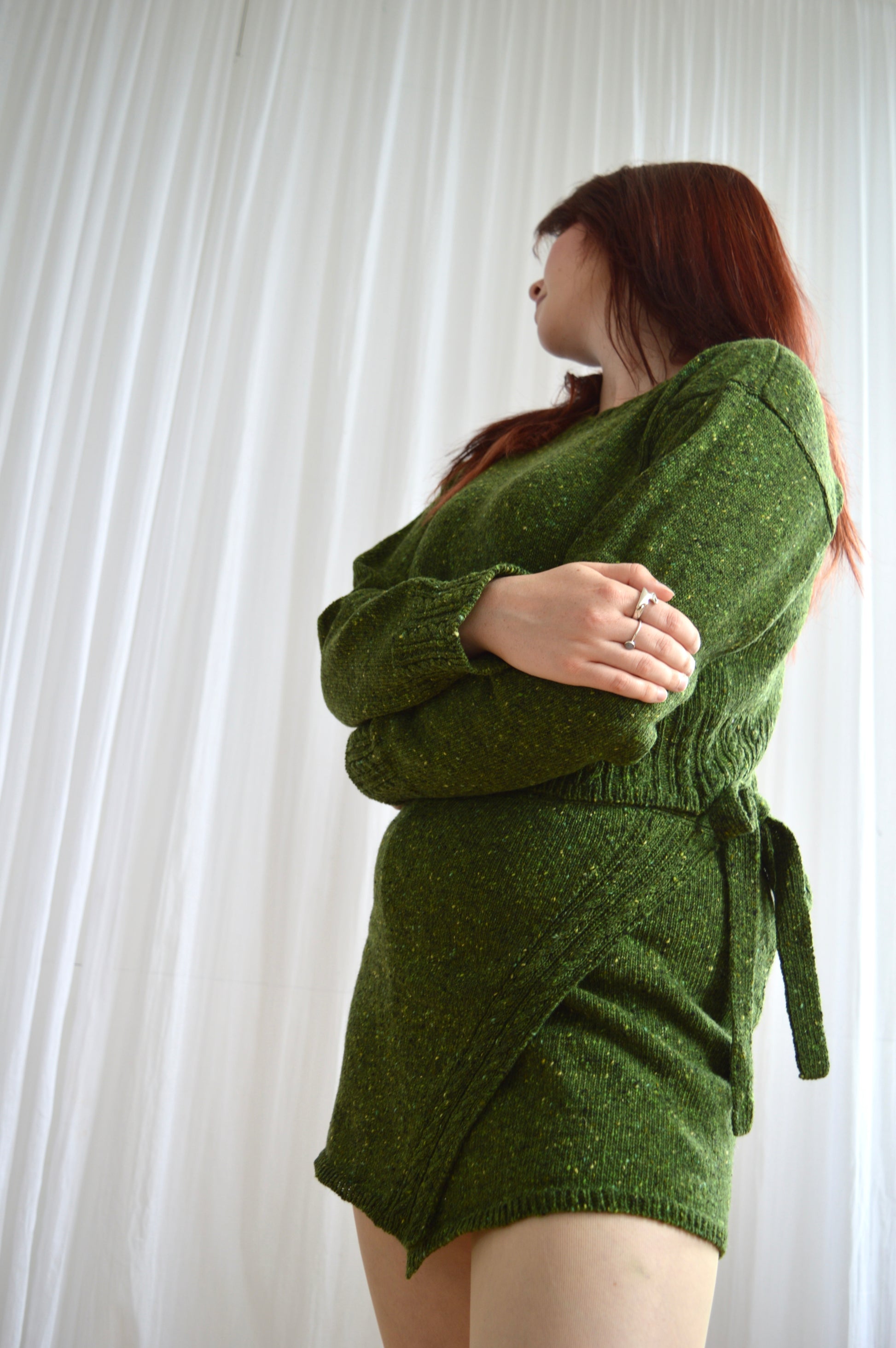 Low angle shot of model wearing The Wrap Skirt in green